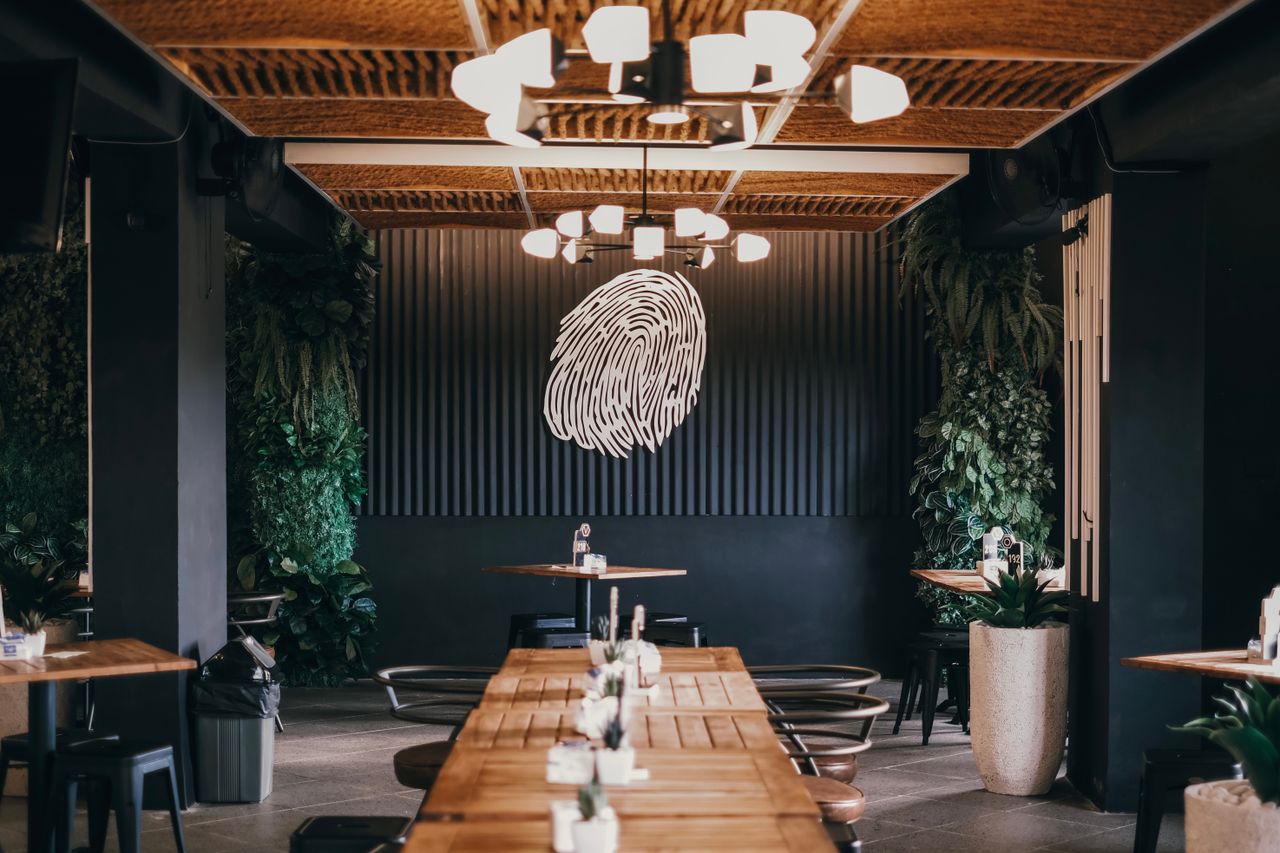 Elegant restaurant interior with wooden furniture and unique wall decor.